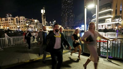 People run away as a fire engulfs the nearby The Address Hotel (not pictured) in downtown Dubai. Ahmed Jadallah / Reuters