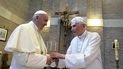 Pope Francis, left, and Pope Benedict XVI, meet each other on the occasion of the elevation of five new cardinals at the Vatican. AP