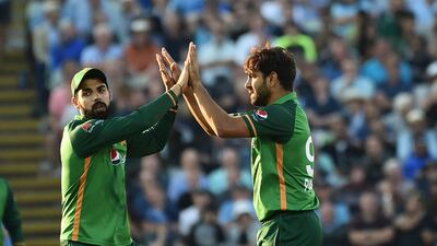 Pakistan's Haris Rauf, right, celebrates with Pakistan's Shadab Khan after dismissing England's James Vince.