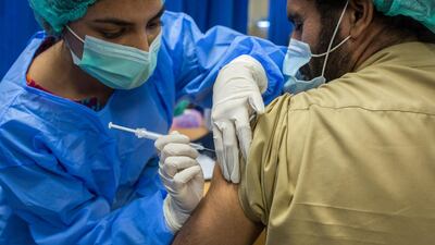 A health worker administers a dose of the Sinopharm Covid-19 vaccine to a colleague in the Adult Vaccination Center at the Dow University Hospital in Karachi, Pakistan. Bloomberg