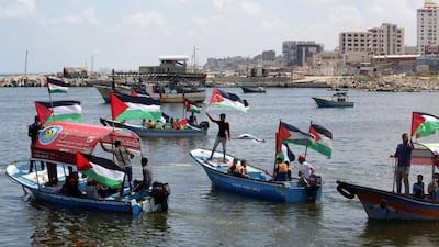 Palestinians ride boats during a rally to show support for activists aboard the so-called Freedom Flotilla III, which set sail from Crete on June 26, 2015. The flotilla of boats hopes to reach the shores of the Gaza Strip by the end of the month, breaking Israel's blockade of the territory. AFP Photo/Mahmud Hams