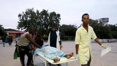 Paramedics and civilians carry an injured person on a stretcher at Madina hospital after a blast at the Elite Hotel in Lido beach in Mogadishu, Somalia. Reuters