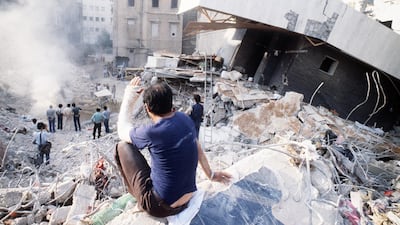 A man sits on rubble in a desolated area of west Beirut on August 20, 1982. AFP