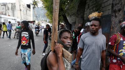 A man poses for a photograph during anti-government protests in Port-au-Prince. Reuters