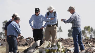 Investigators with the NTSB look over debris at the crash site. Getty Images