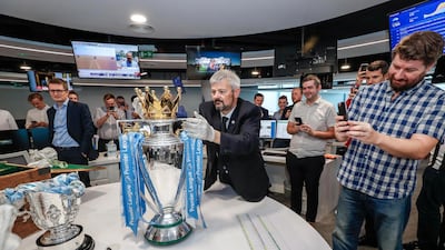 The Premier League trophy and Carabao Cup visit The National newsroom.
