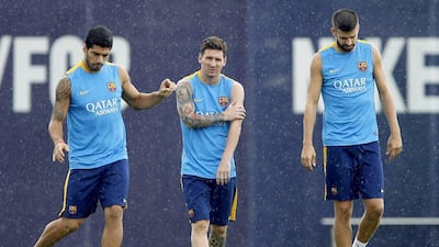 Barcelona players Luis Suarez, Lionel Messi and Gerard Pique shown at a team training session on Thursday at the club's Joan Gamper centre outside Barcelona. Andreu Dalmau / AFP