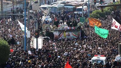 A large crowd surrounds the coffins of Qassem Suleimani and Abu Mahdi Al Muhandis as they are transported atop a vehicle after their arrival at Ahvaz International Airport in southwestern Iran. AFP