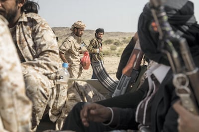Ahmed Omar, left, with other members of Yemeni resistance forces of Abu Jabr brigade. Asmaa Waguih for The National