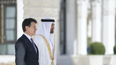 Sheikh Mohamed bin Zayed and Giuseppe Conte stand for the national anthem, during a reception held at the Presidential Palace. Mohammed Al Hammadi / Ministry of Presidential Affairs