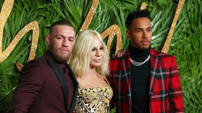 Italian designer Donatella Versace, British Formula One driver Lewis Hamilton and Conor McGregor at the British Fashion Awards at the Royal Albert Hall in London on December 4, 2017.