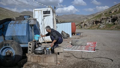A petrol vendor draws supplies from Iranian fuel oil tankers near the Bashmagh border crossing. Iran's oil products include crude and diesel, petrol and naphtha. AFP