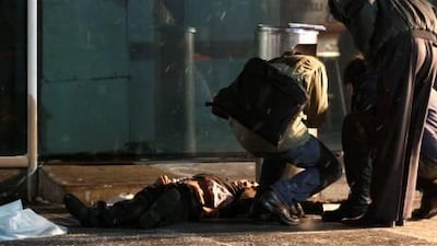 Investigators work near the lifeless body of a man killed in an explosion at Domodedovo airport in Moscow.