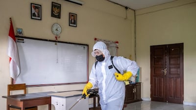 An official sprays disinfectant inside a school amid the ongoing coronavirus pandemic in Denpasar, Bali, Indonesia. EPA