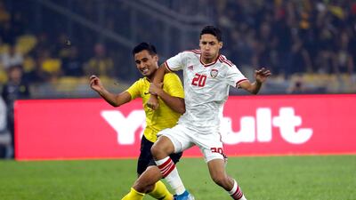 UAE's Ali Saleh, right, battles for possession with Matthew Davies of Malaysia. AP