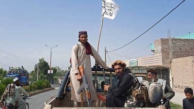 Taliban fighters drive through the streets of Laghman province.