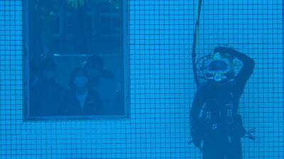 Taiwan President Tsai Ing-wen (centre behind observation window) watches a diver while visiting the Underwater Operation Unit at a naval base in Kaohsiung. AFP