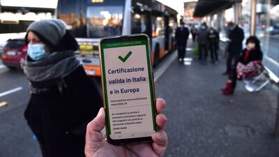 A passenger shows green pass on his mobile phone at Brignole bus stop in Genoa, Italy. EPA