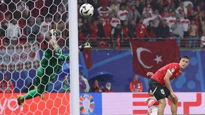 Turkey goalkeeper Mert Gunok saves a shot late in the game from Christoph Baumgartner of Austria with a brilliant reflex parry. EPA