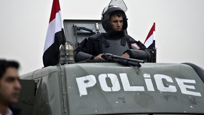 An Egyptian policeman stands guard from an armoured vehicle outside the venue of the trial of the ousted Islamist president Mohammed Morsi on February 16. Khaled Desouki / AFP