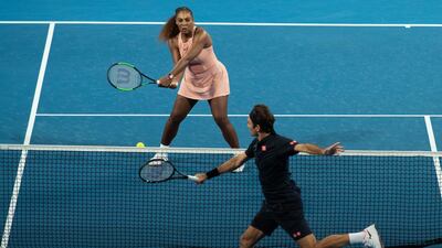 Serena Williams of the USA and Roger Federer of Switzerland in action during the mixed doubles match. EPA
