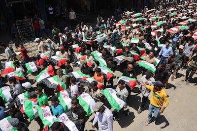 Mourners carry the remains of members of the Abu Sharia and Al Hassayneh families recovered from the rubble of buildings in the Al Sabra neighbourhood of Gaza city. AFP