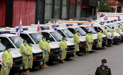 Islamic Health Society ambulances and personnel line up in southern Beirut during a media tour organised by Hezbollah on March 31, 2020. Reuters
