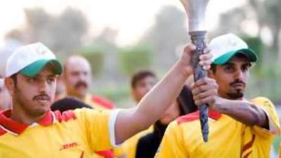 Special Olympians hold the torch during a ceremony at the Emirates Palace.