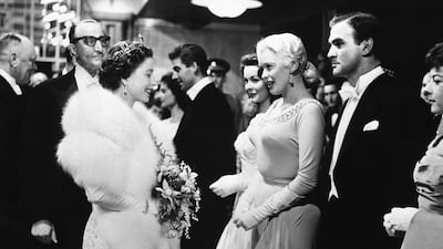The queen with US actress Jayne Mansfield and British actor Stanley Baker at the Odeon Theatre in London. AP