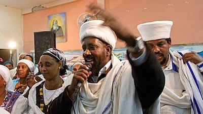 An Ethiopian kess - Amharic for priest - blesses a newly-wed couple in Ashkelon, southern Israel.