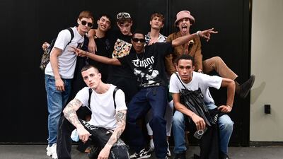 Models pose after the Dolce & Gabbana men's show in Milan on June 19, 2021. AFP