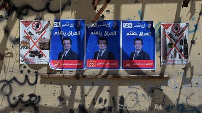 Election campaign posters are seen plastered on the wall of a destroyed building in the former embattled city of Mosul on May 1, 2018 ahead of the upcoming Iraqi parliamentary elections. Zaid Al-Obeidi / AFP