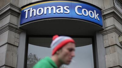 A pedestrian walks past a Thomas Cook shop in central London. Suzanne Plunkett / Reuters
