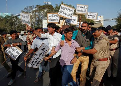 A police officer tries to detain a member of the Rajput youth wing during a protest against the release of the upcoming Bollywood movie Padmaavat in Ahmedabad, India on January 23, 2018. Amit Dave / Reuters
