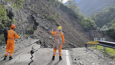 National Disaster Response Force personnel assess the damage to a road amid an attempt to rescue stranded pilgrims in Kedarnath. AFP