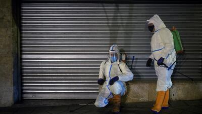 Two cleaning workers disinfect the streets of Ourense, in Galicia, northwestern Spain. EPA