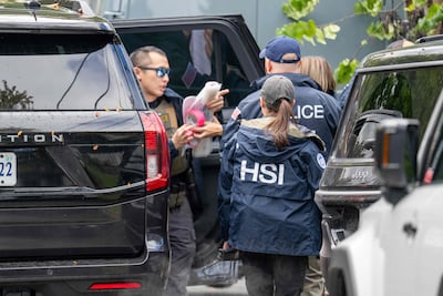 Homeland Security Investigations officers remove documents from the Washington home of US Democratic Representative Ilhan Omar on October 12. AFP