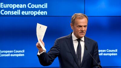 European Council President Donald Tusk holds up the document from the UK during a media conference at the Europa building in Brussels on Wednesday, March 29, 2017. Tusk has received a letter from British Prime Minister Theresa May, invoking Article 50 of the bloc's key treaty, the formal start of exit negotiations. (AP Photo/Virginia Mayo)