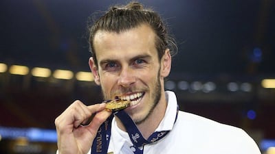Real Madrid's Gareth Bale bites his winners medal at the end of the Uefa Champions League final against Juventus at the Millennium Stadium in Cardiff, Wales, Saturday, June 3, 2017. Real won the match 4-1. Frank Augstein / AP Photo