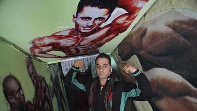 The owner of a bodybuilding club flexes his muscles.