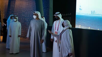 Sheikh Mohamed bin Zayed is briefed on the exhibits at the Kuwait pavilion.