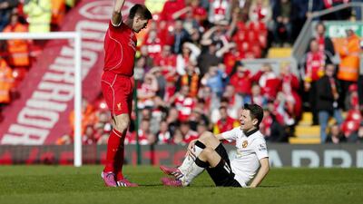 Liverpool's Steven Gerrard looks at Ander Herrera of Manchester United after fouling him shortly after the start of the second half, a stamp that earned him a red card. Phil Noble / Reuters