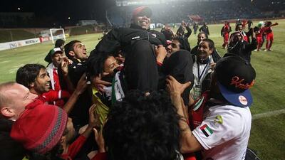 UAE players celebrate by hoisting the Olympic team coach, Madi Ali, in the air after battling back to beat Uzbekistan 3-2 in Tashkent to qualify for the 2012 Olympics. Sammy Dallal / The National