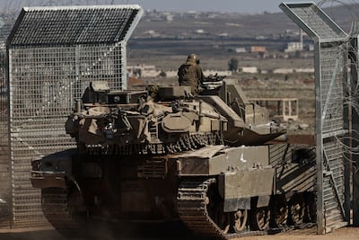 An Israeli tank enters the buffer zone between Israel and Syria in March. EPA