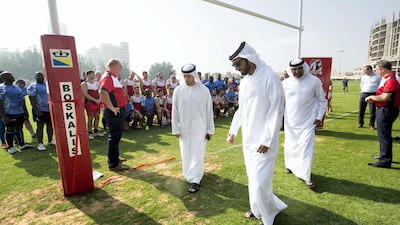 Emirati officials join the teams for the first game and inspect the pitch - which is shared with a golf club