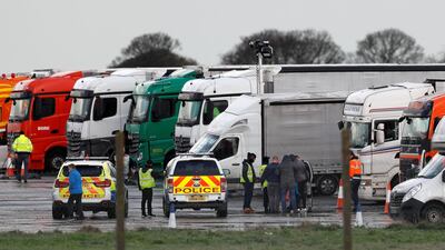 Drivers gather next to the lorries parked at Manston International Airport, after EU countries imposed a travel ban from the UK following the coronavirus disease (COVID-19) outbreak, in Manston, Britain. REUTERS