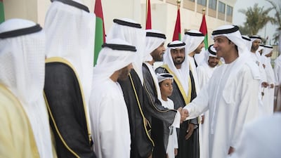 Sheikh Hazza bin Zayed, Vice Chairman of the Abu Dhabi Executive Council, right, greets a groom during a group wedding at Majlis Al Bateen. Boris Dejanovic for the Crown Prince Court - Abu Dhabi