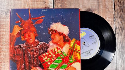 R18JP7 Last Christmas - WHAM 7inch single on a wooden background produced in 1984 George Michael