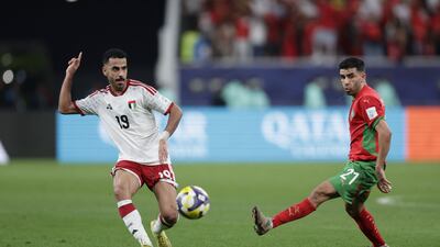 UAE defender Khaled Ibrahim passes the ball under pressure from Morocco's Karim Al Berkaoui. AFP
