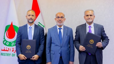 Iraq's Minister of Oil Bassim Mohammed, middle, oversees the signing ceremony between state-run Basra Oil Company and US oilfield services giant Halliburton. Photo: Iraq Oil Ministry